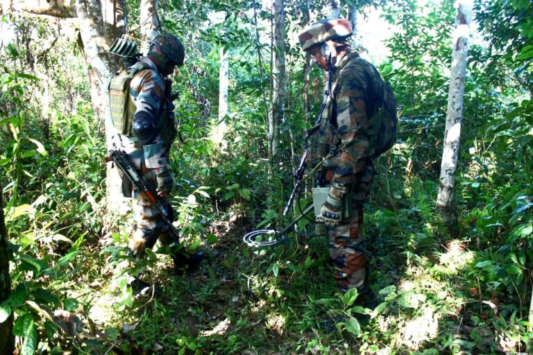 Indian Army and Assam Rifles personnel using metal detectors during a joint operation in the dense forests of Manipur