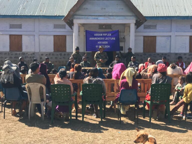 Assam Rifles officials interacting with villagers during the World AIDS Day awareness session in Nungba.