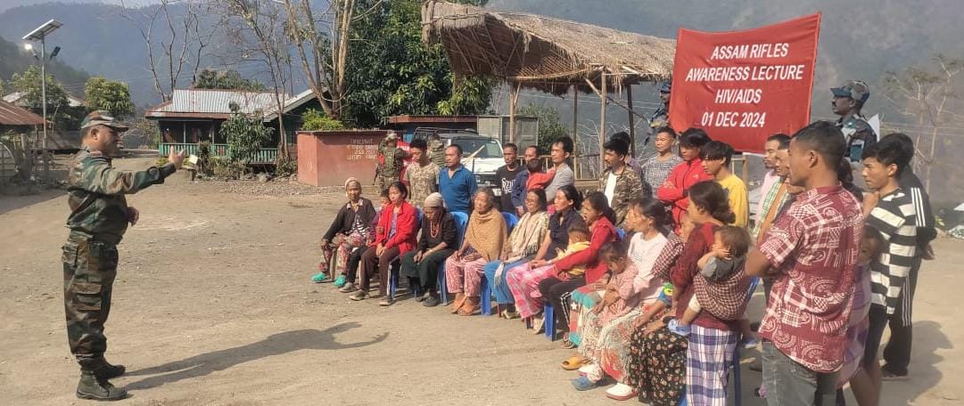 Villagers and Assam Rifles officials attending a World AIDS Day awareness program in Nungba, Manipur.