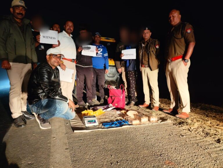 Assam Police officials displaying seized YABA tablets along with apprehended suspects during a press briefing in Silchar.