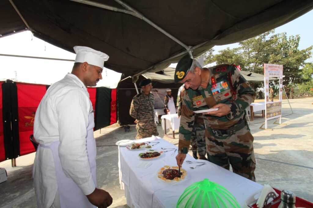 An Assam Rifles officer inspecting millet-based dishes displayed in a buffet during the cooking competition at Srikona Garrison.