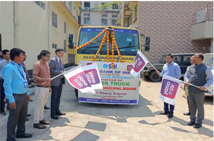 SBI officials handing over a dumper vehicle to Silchar Municipal Board for improved waste management.