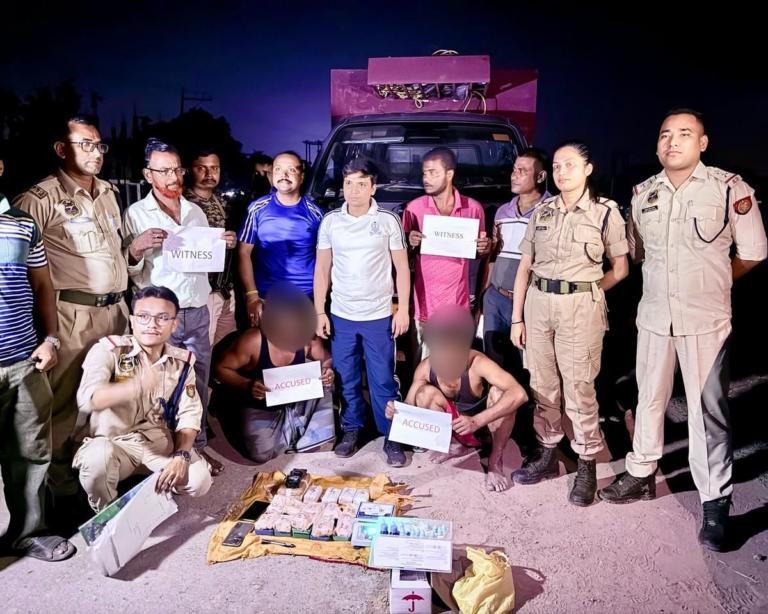 Cachar Police officers displaying seized heroin, Yaba tablets, and two arrested suspects near Silchar Bypass.