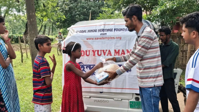 Hindu Youth Forum volunteers providing flood relief to Christian families in Borkhola, Barak Valley
